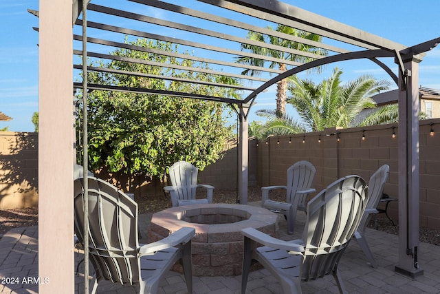 view of patio / terrace with a fire pit and a pergola