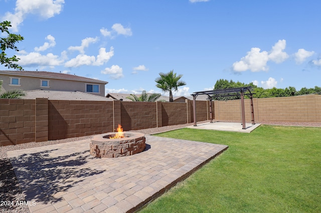 view of yard featuring an outdoor fire pit and a patio area