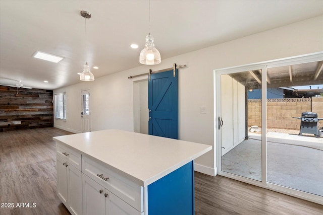 1939 E Alameda Dr, Tempe, AZ 85282 - kitchen with dark wood-style floors, a barn door, white cabinets, light countertops, and recessed lighting