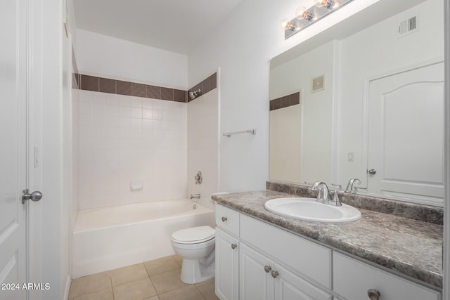 full bathroom featuring tile patterned flooring, vanity, tiled shower / bath combo, and toilet