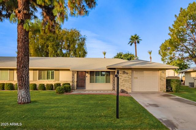 single story home with a garage and a front lawn