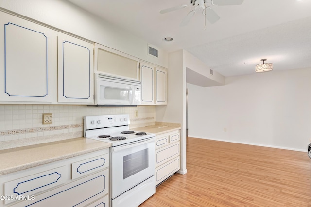 kitchen with white appliances, white cabinetry, decorative backsplash, light hardwood / wood-style flooring, and ceiling fan