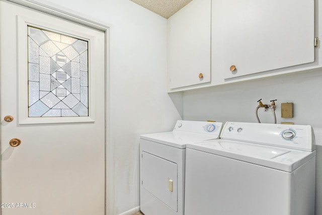 laundry area with separate washer and dryer and cabinets