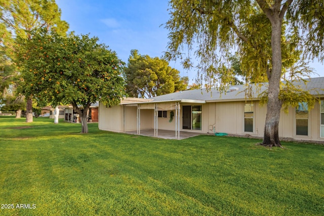 rear view of property with a patio area and a yard