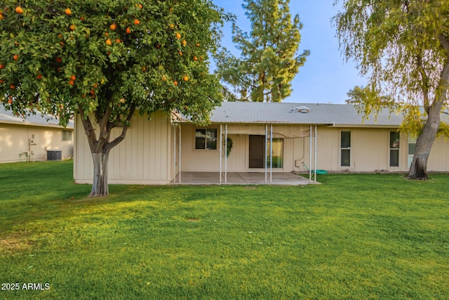 back of house featuring a patio, central air condition unit, and a lawn