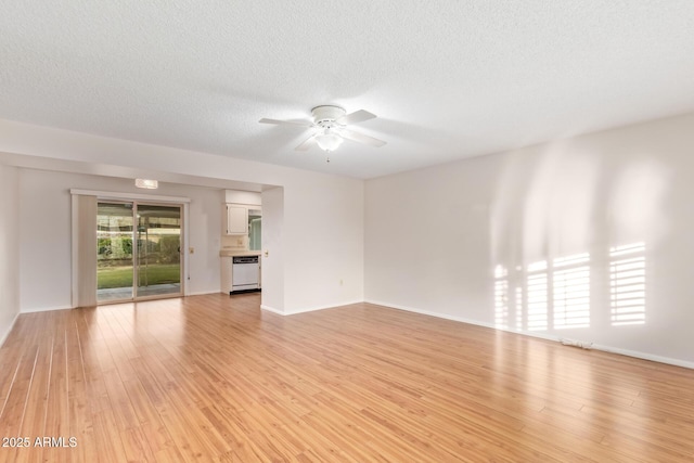 unfurnished living room with ceiling fan, a textured ceiling, and light wood-type flooring