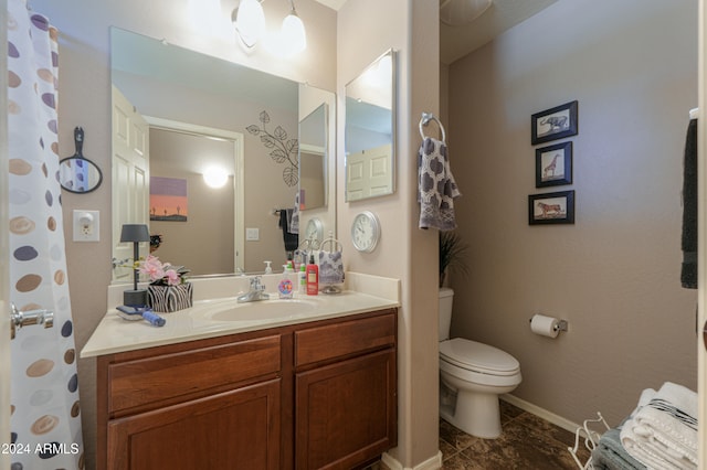 bathroom featuring tile patterned flooring, vanity, and toilet