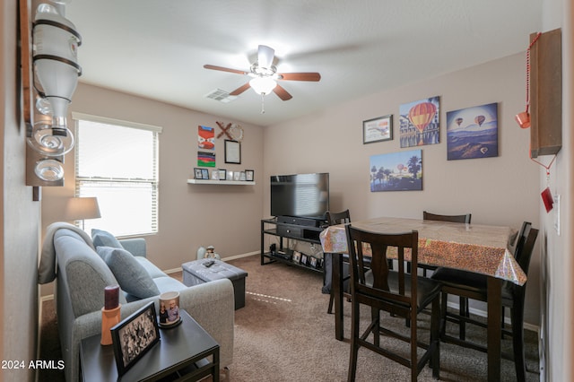 carpeted living room with ceiling fan