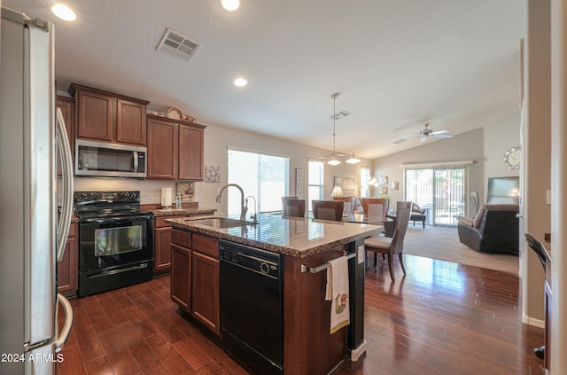 kitchen with vaulted ceiling, an island with sink, dark hardwood / wood-style flooring, black appliances, and sink