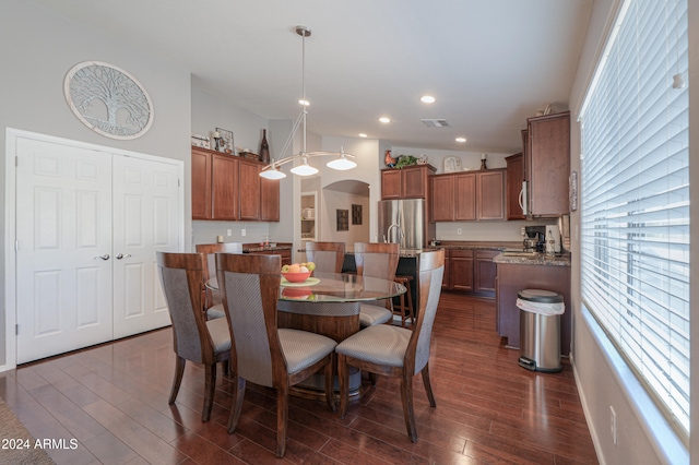 dining room featuring lofted ceiling and dark hardwood / wood-style floors