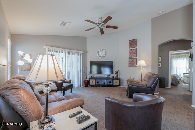 carpeted living room with vaulted ceiling and ceiling fan