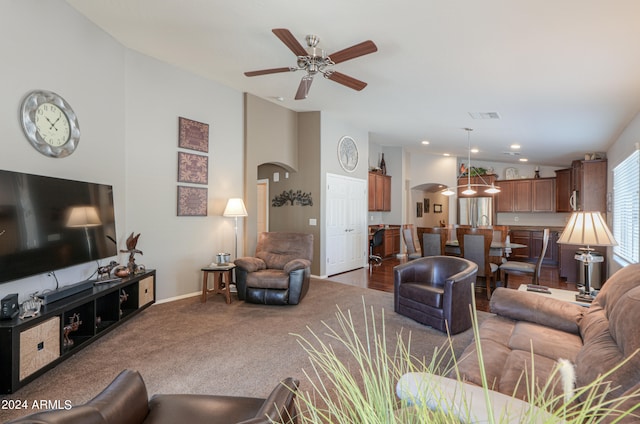 carpeted living room with ceiling fan