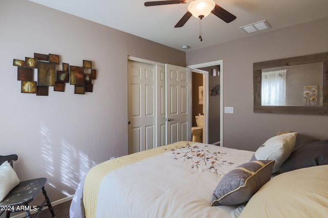 bedroom featuring ceiling fan, a closet, ensuite bath, and carpet flooring