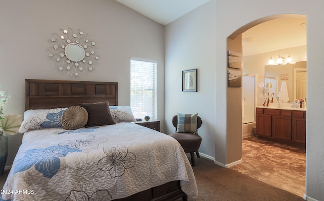 tiled bedroom with connected bathroom and vaulted ceiling