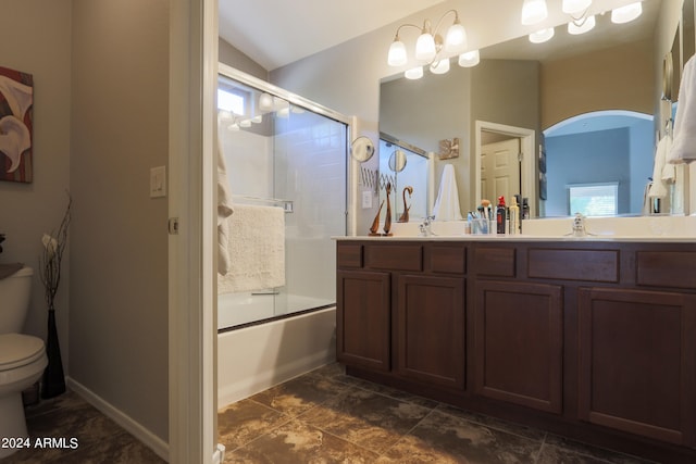 full bathroom featuring vaulted ceiling, vanity, toilet, and shower / bath combination with glass door