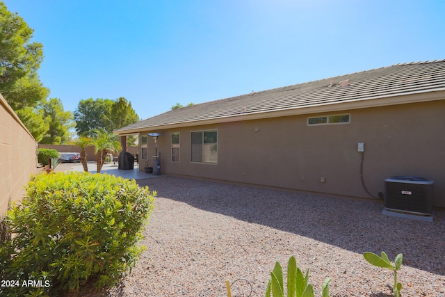 rear view of property featuring a patio and central AC unit