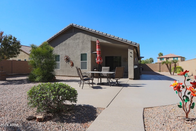 back of property with a patio