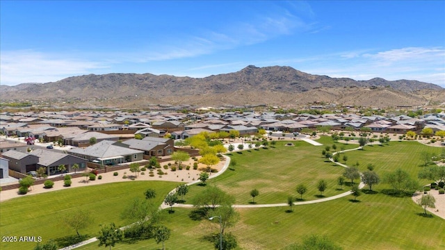 aerial view of property's location featuring nearby suburban area and a mountainous background