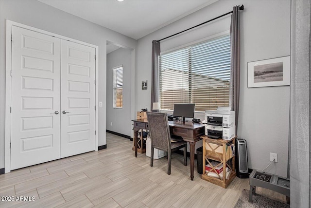 office area with light wood-style flooring and baseboards