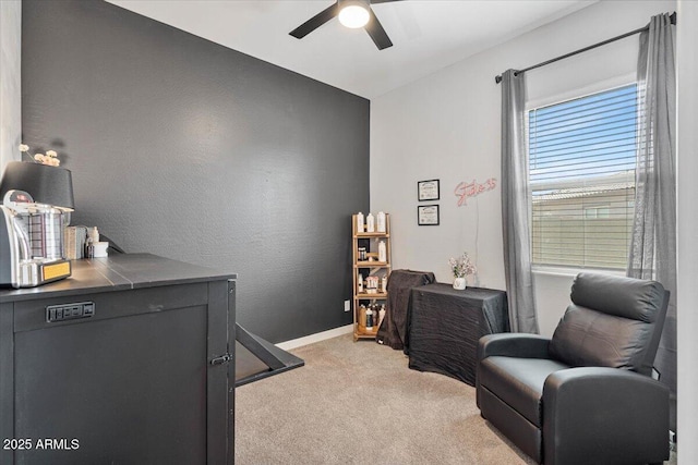 sitting room featuring light carpet, ceiling fan, and baseboards