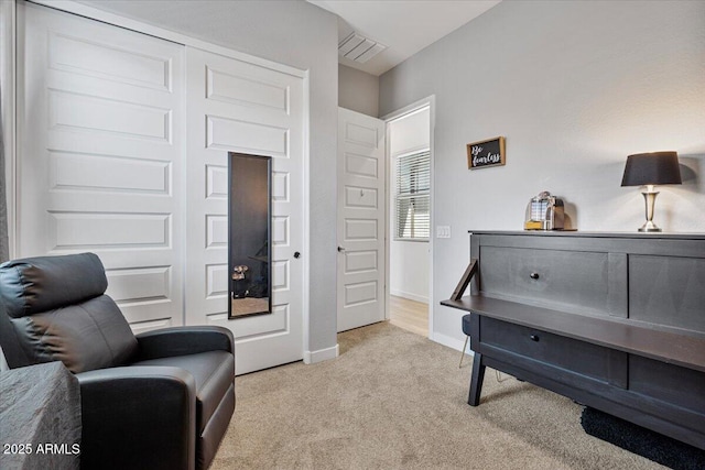 sitting room featuring carpet floors and baseboards