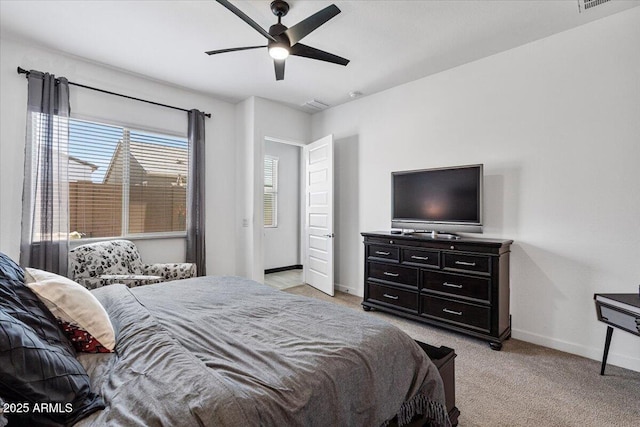 bedroom featuring baseboards, light carpet, and ceiling fan