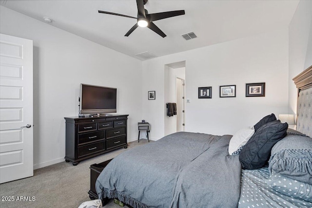 bedroom with light colored carpet, baseboards, and a ceiling fan
