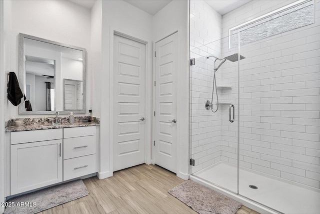 bathroom with a stall shower and vanity