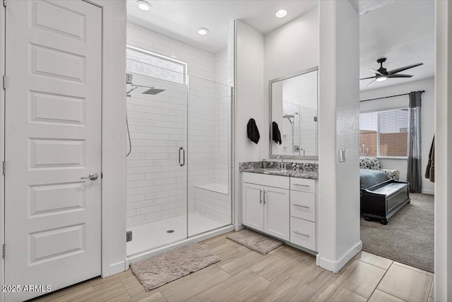 bathroom featuring ensuite bathroom, a stall shower, vanity, and a ceiling fan