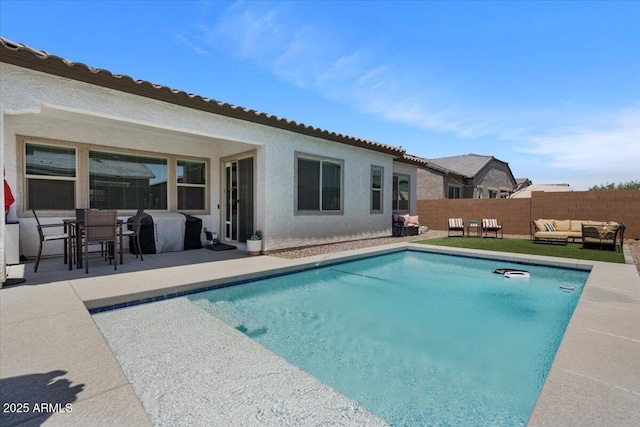 view of swimming pool featuring an outdoor living space, a patio, a fenced backyard, and area for grilling