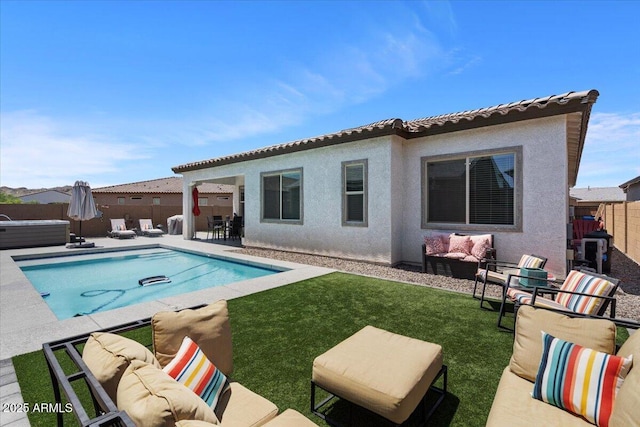 back of property featuring outdoor lounge area, a patio area, and stucco siding