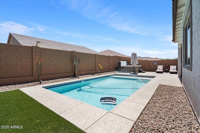 view of pool with a fenced backyard and a patio