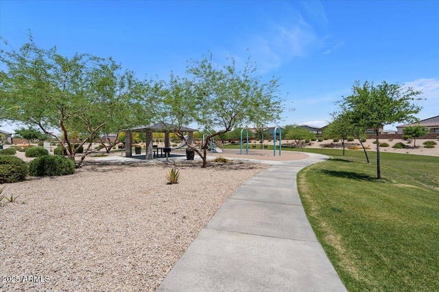 view of property's community with a lawn and a gazebo