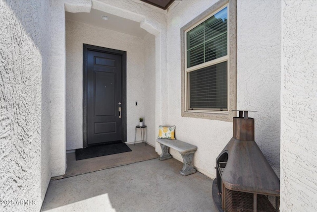 property entrance featuring stucco siding