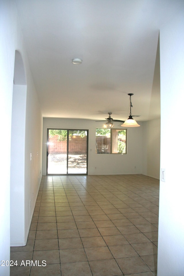 unfurnished room featuring ceiling fan and light tile patterned floors