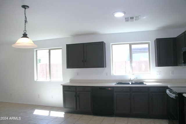 kitchen featuring a healthy amount of sunlight, hanging light fixtures, dishwasher, and sink