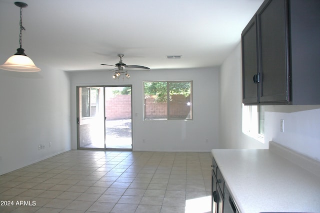 interior space with light tile patterned flooring and ceiling fan