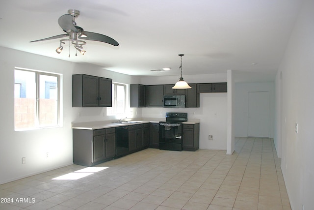 kitchen with pendant lighting, black appliances, sink, ceiling fan, and light tile patterned flooring