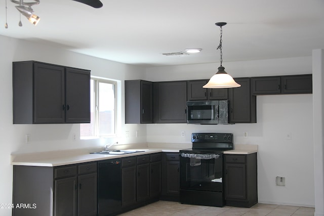 kitchen with hanging light fixtures, light tile patterned floors, sink, black appliances, and ceiling fan