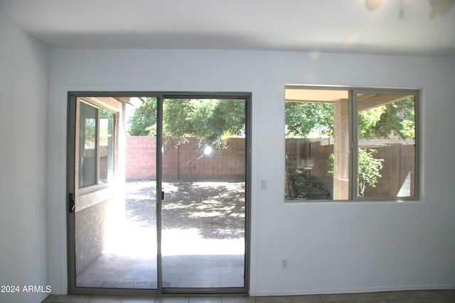 doorway to outside featuring tile patterned floors