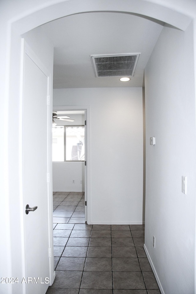 hallway featuring tile patterned flooring