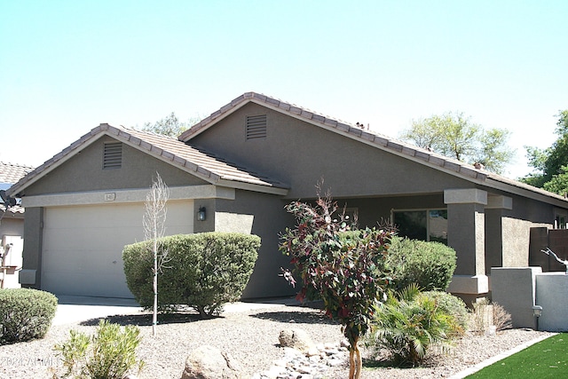 ranch-style home featuring a garage