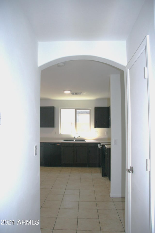 kitchen featuring light tile patterned flooring and sink