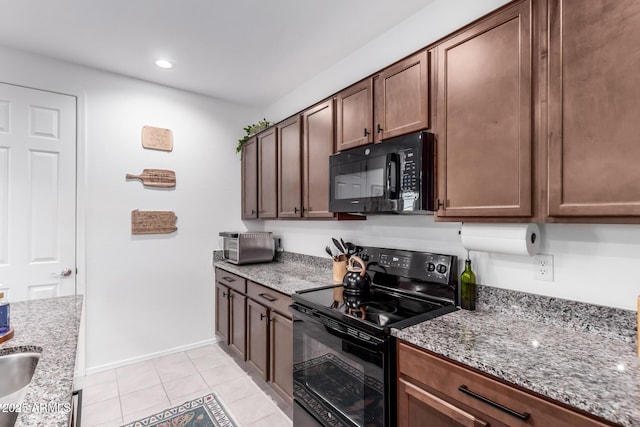 kitchen featuring black appliances, light stone counters, recessed lighting, light tile patterned floors, and baseboards