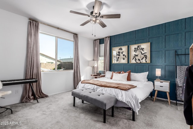 carpeted bedroom featuring baseboards and ceiling fan