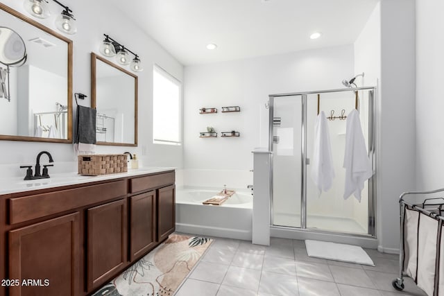 bathroom featuring visible vents, double vanity, a stall shower, a sink, and a bath