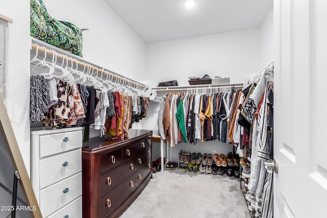 walk in closet with carpet