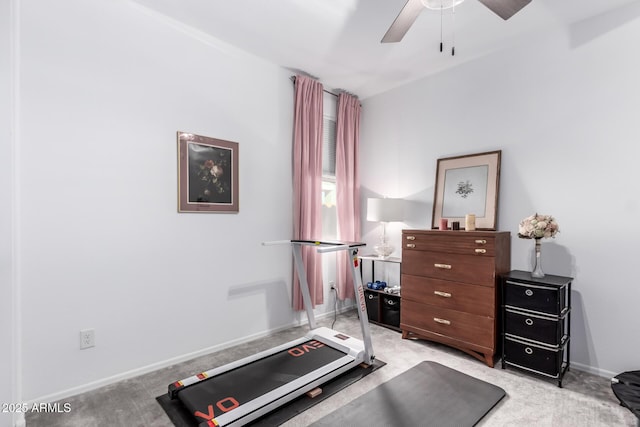 workout room with light colored carpet, baseboards, and ceiling fan