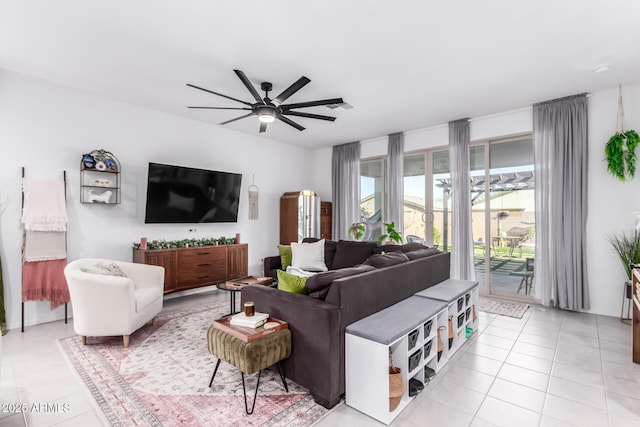 living area with light tile patterned flooring and a ceiling fan