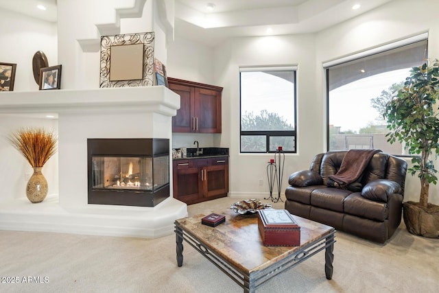 carpeted living room with indoor bar and a multi sided fireplace